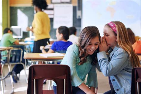 Friends Whisper And Gossip In Classroom For Secret Talking Or