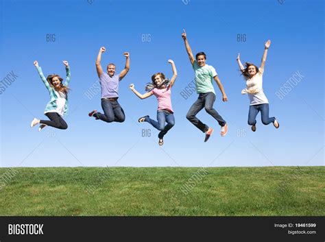 Group Of Happy Young People Jumping In The Air Stock Image Image Of