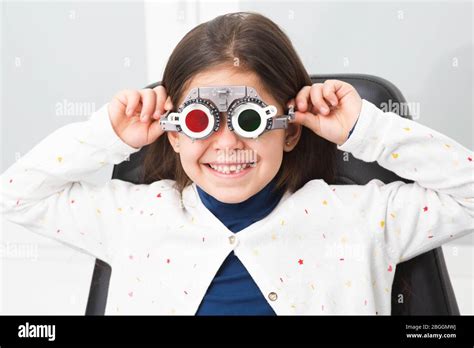 Mixed Race Girl Wearing Optometrist Trial Frame At Ophthalmology Clinic